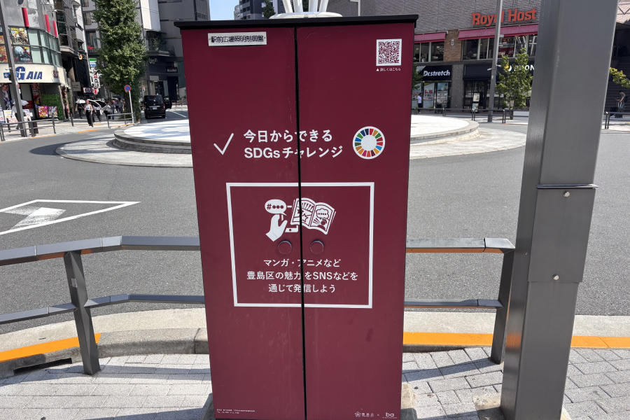 SDGs分電盤の写真。「マンガ・アニメなど豊島区の魅力をSNSなどを通じて発信しよう」と書かれた赤褐色の分電盤。