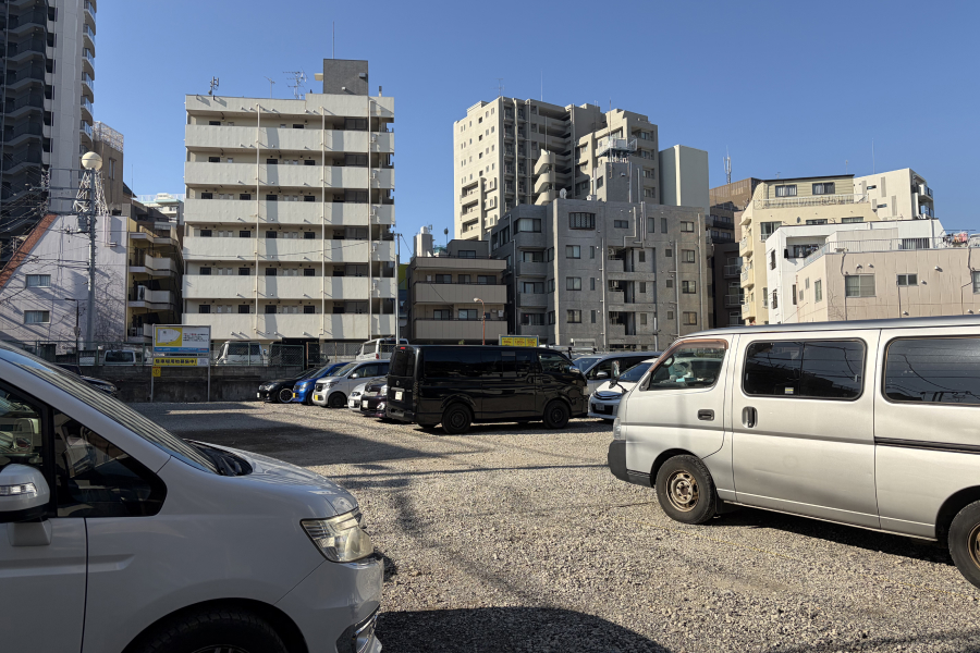 老人ホーム建設予定地の現在の状況の写真。大きな駐車場となっている。